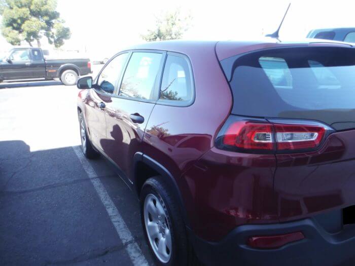 After repair of a red car, showing the rear is fully repaired and detailed.