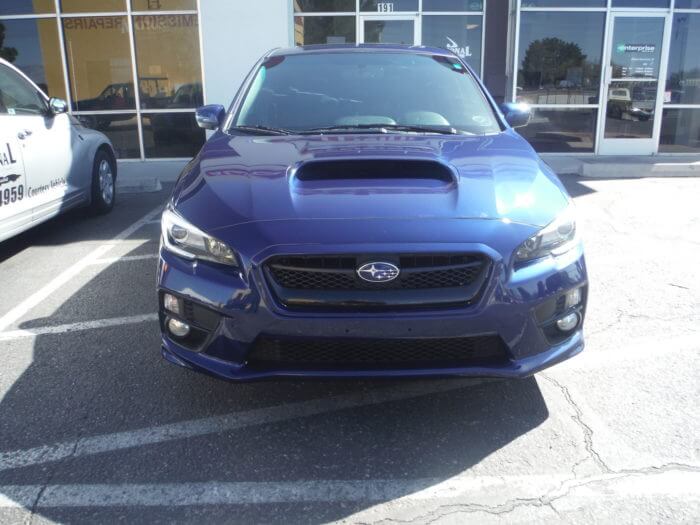 After repair of a blue Subaru, showing the front bumper is repaired and restored.